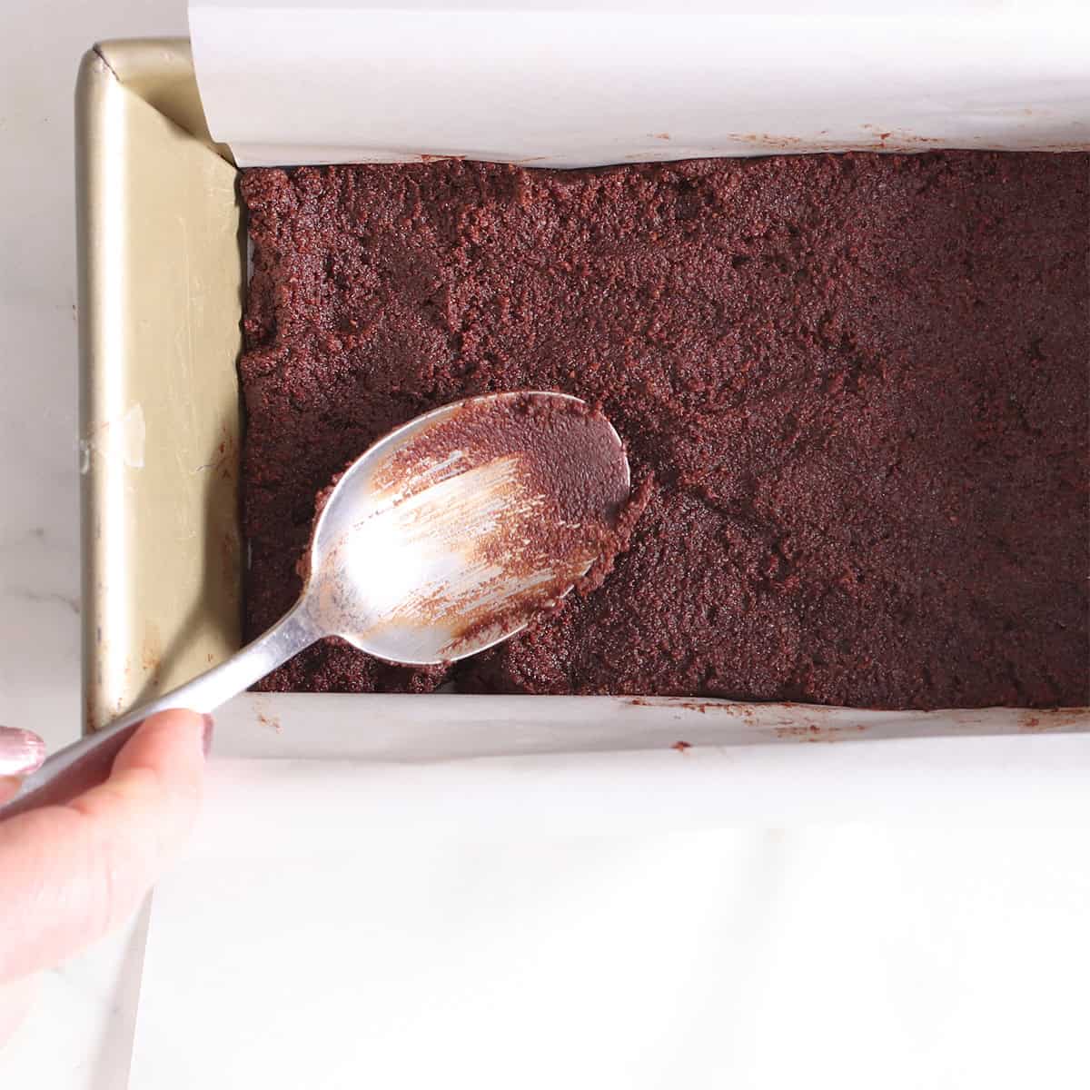 Press the chocolate cheesecake bar crust into a loaf pan.