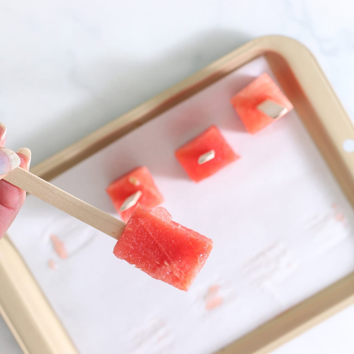 put sticks in chocolate watermelon pops.